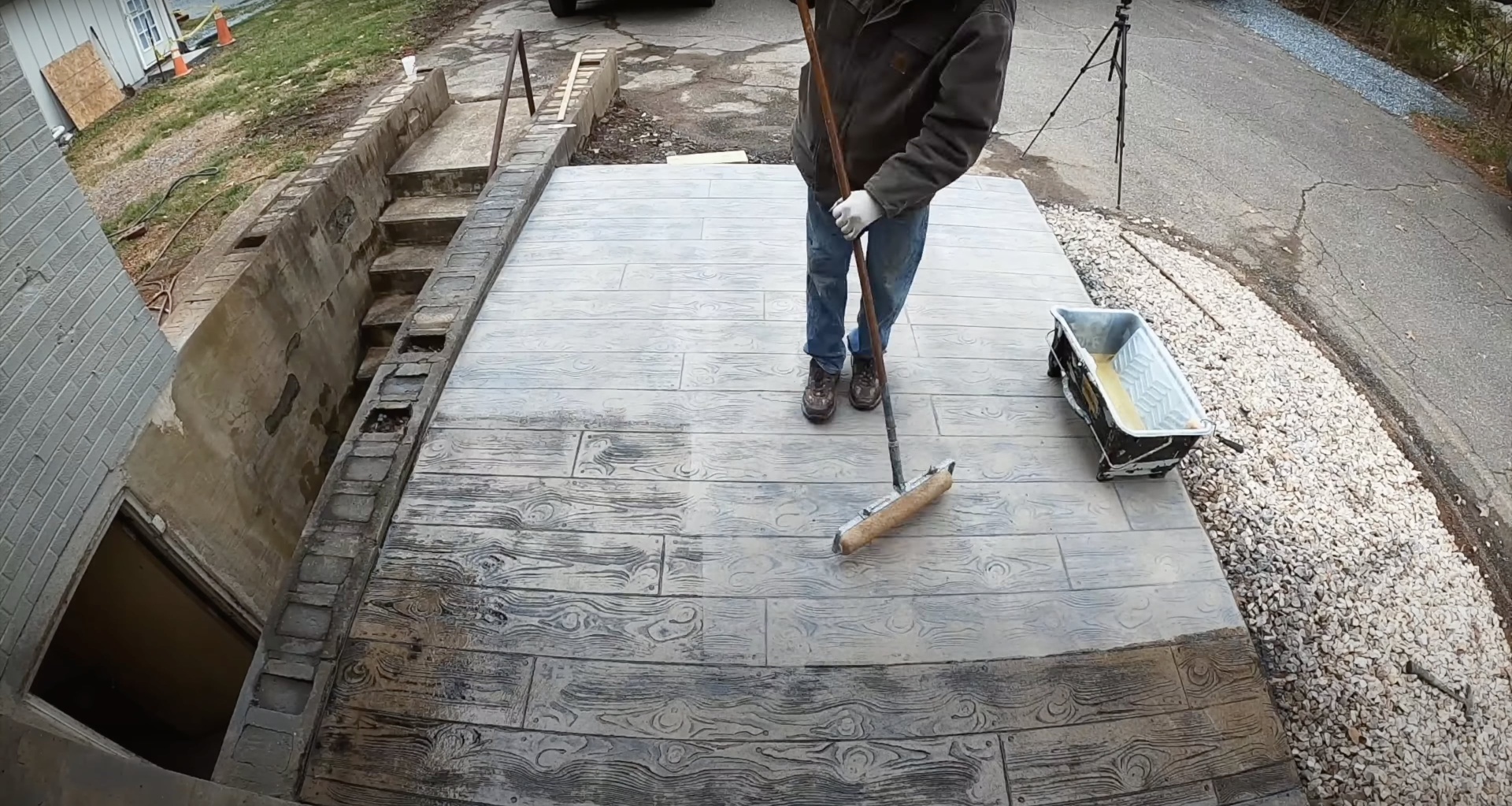 Decorative stamped concrete patio with wood grain finish Stamped concrete patio installation with wood grain pattern texture