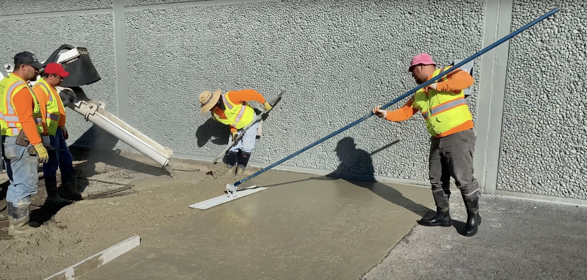 Professional concrete finishing and smoothing Construction workers applying professional concrete finishing techniques