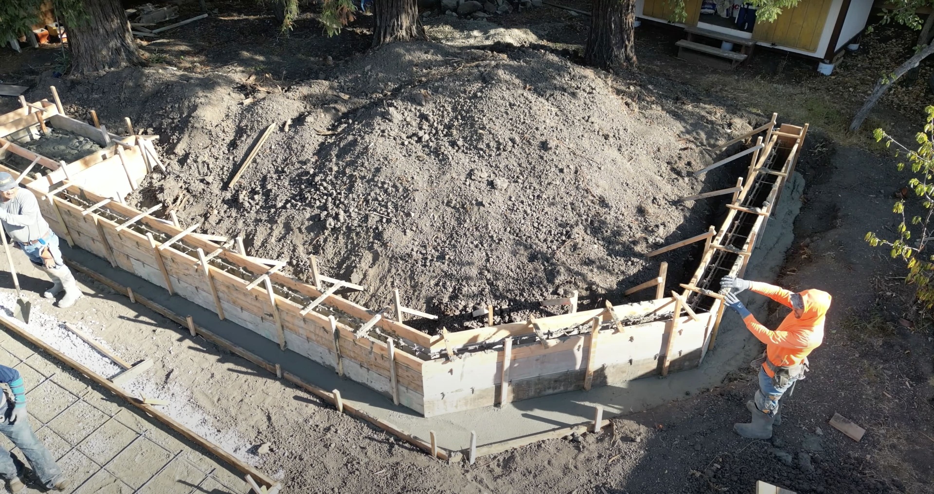 Professional concrete foundation installation Construction site with concrete foundation forms and workers