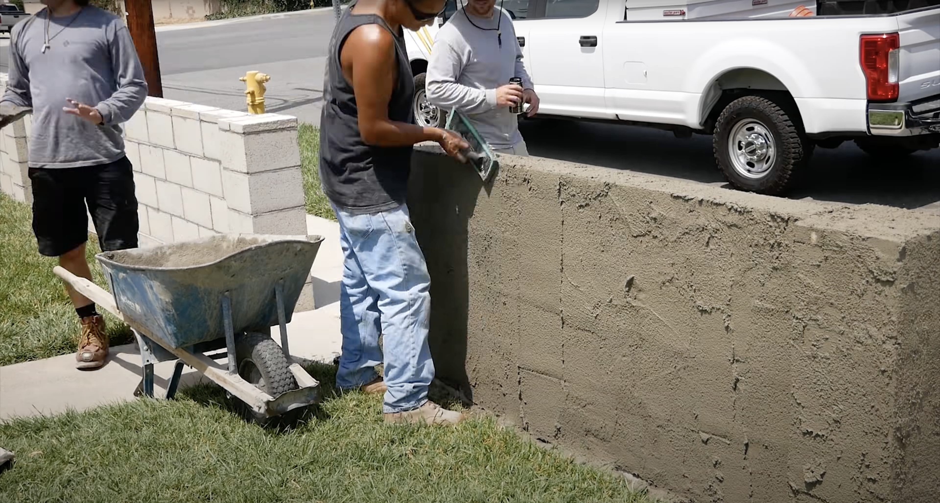 Professional concrete driveway installation process Concrete contractors pouring fresh concrete for residential driveway installation