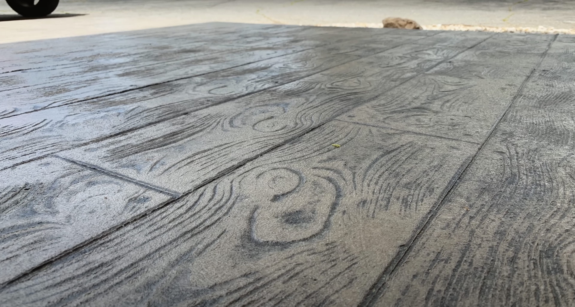 Wood plank stamped concrete driveway installation Stamped concrete driveway with detailed wood plank pattern texture